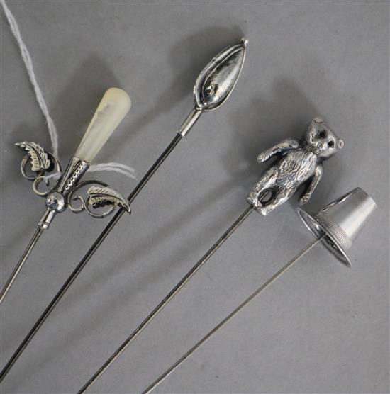 Four early 20th century silver mounted hat pins, including hat by Charles Horner.